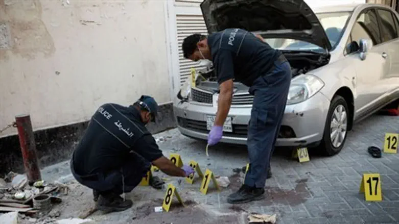Bahraini police inspect the site of an explos