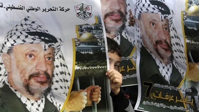 Posters of former PA Chairman Yasser Arafat