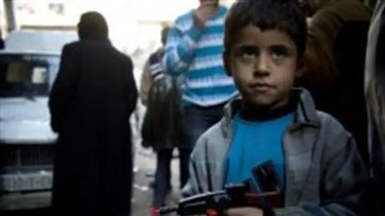  Syrian boy holds toy pistol in Aleppo, where