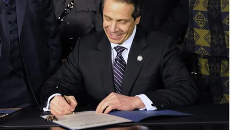 New York Governor Andrew Cuomo signs the New 