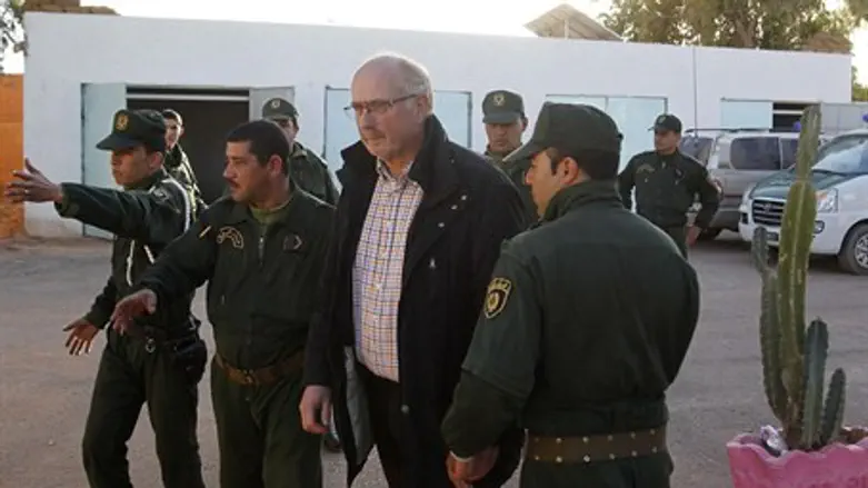 Algerian security escorts a freed hostage