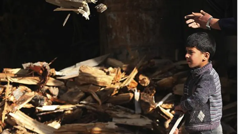 Boy carries firewood in Damascus's Duma neigh