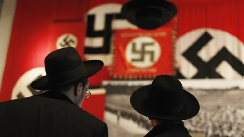 Jews look at a display of Nazi flags (file)