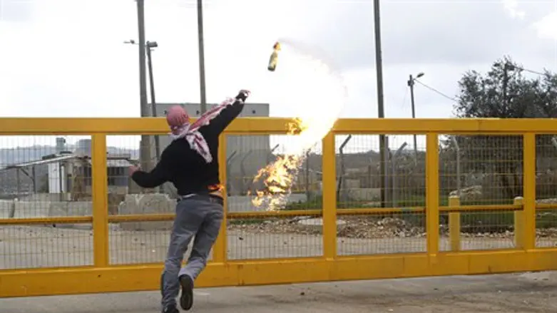 PA protester throws a Molotov cocktail toward