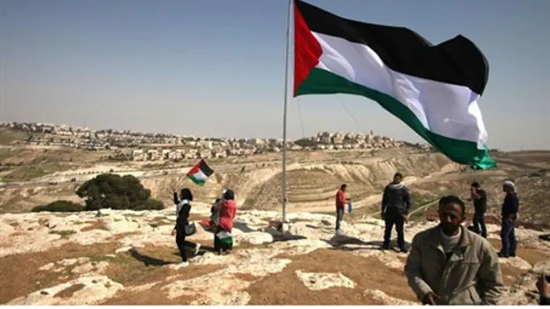 PA Arabs hoist a PLO flag close to Maale Adum