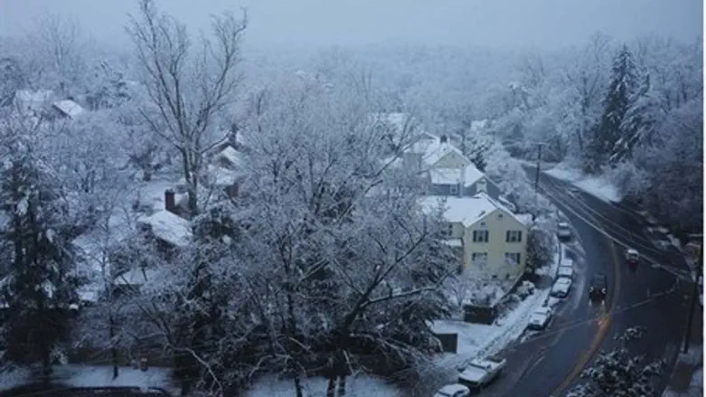 Snow falls over a residential neighbourhood 