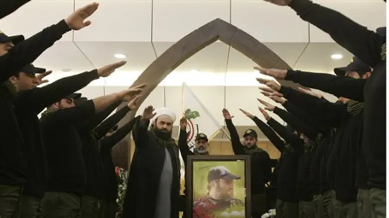 Islamist Hezbollah supporters salute at memor