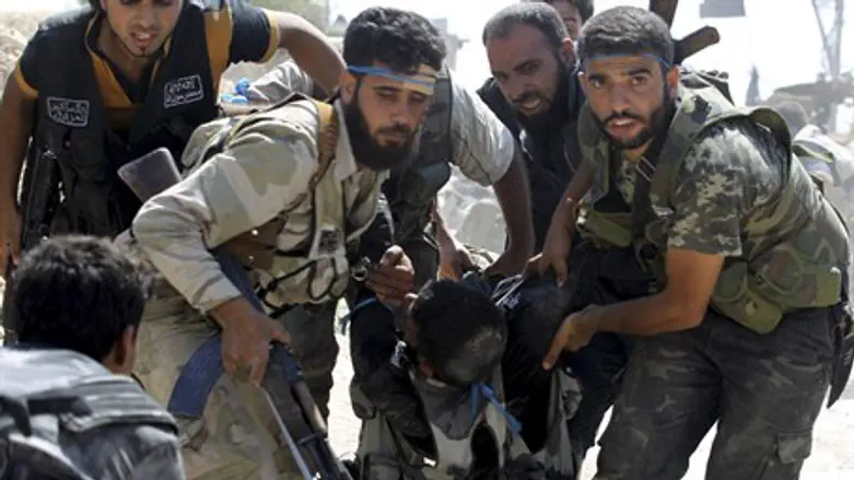Syrian rebels carry wounded fighter in Aleppo