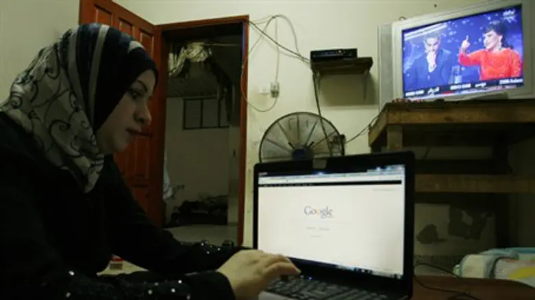Woman uses computer in Gaza