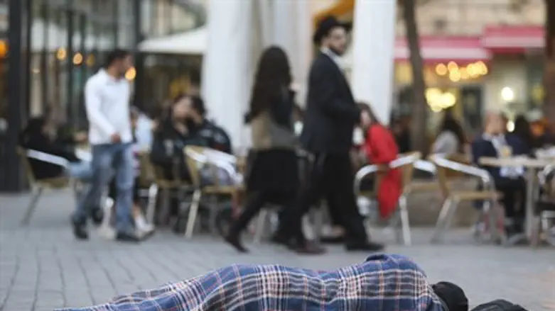 Man sleeps on sidewalk in Jerusalem