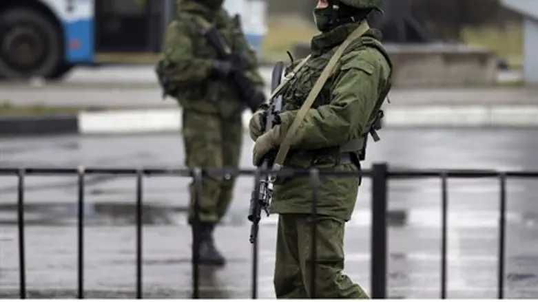 Armed men patrol at the Simferopol airport in