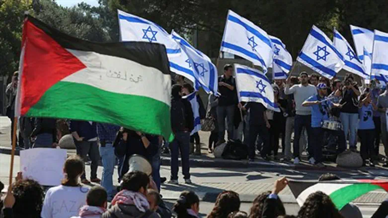 People wave Israeli and PA flags