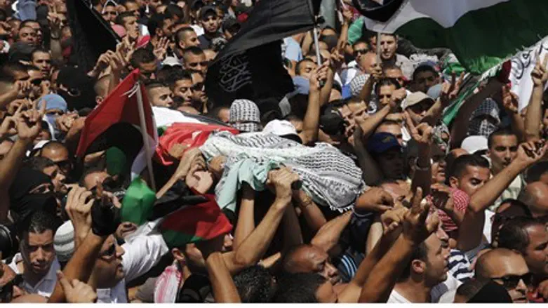 Mourners carry the coffin of Mohammed Abu-Kde