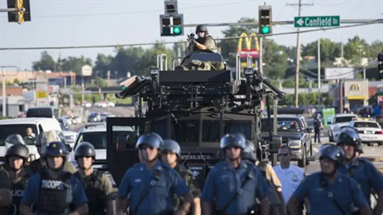 Riot police patrol Ferguson, MO