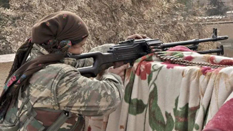 A female Kurdish YPG fighter takes aim at the