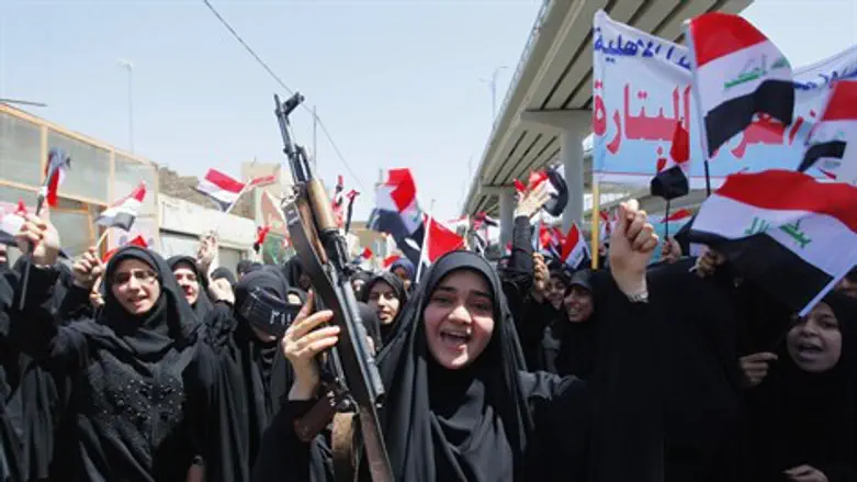 Iraqi Shia women march in support of the gove
