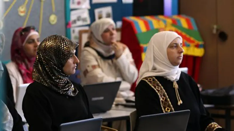 Arab women take a computer class (illustration)