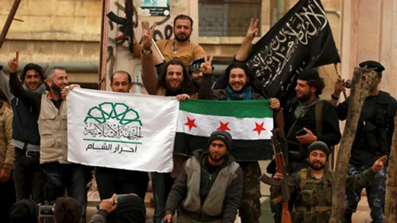 Rebel factions pose with their flags after taking Idlib, Syria (file)