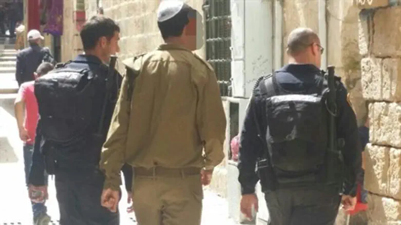 Soldier being led away by police after 'bowing' on Temple Mount