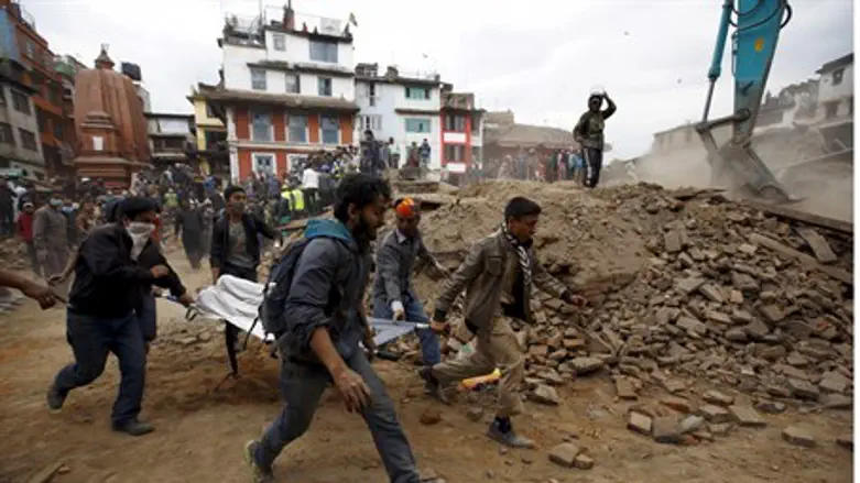 Emergency workers evacuate a body after Nepal earthquake