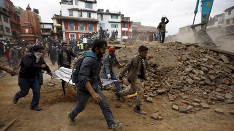 Emergency workers evacuate a body after Nepal earthquake