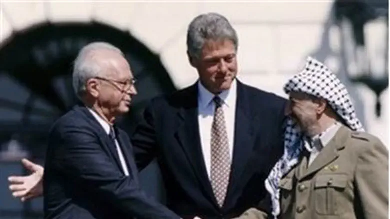 Yitzhak Rabin and Yasser Arafat shake hands at the signing of the Oslo Accords