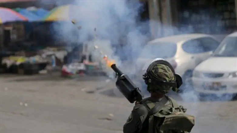 IDF soldier fires tear gas canister (illustration)