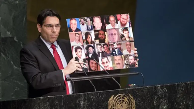 Danon holds up photo of Israeli terror victims