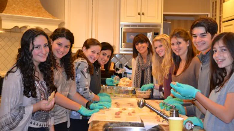 The Fishbein Family and guests preparing Chicken wontons for thanksgiving