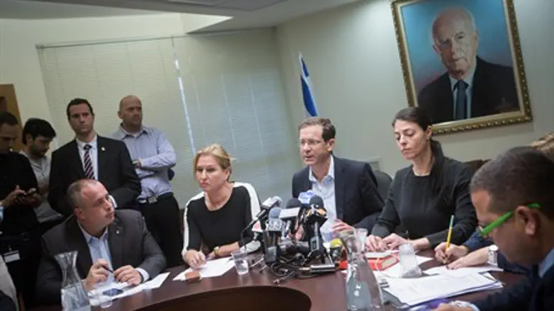 Head of the Zionist Camp party Isaac Herzog (C) leads a party meeting at the Knesset,