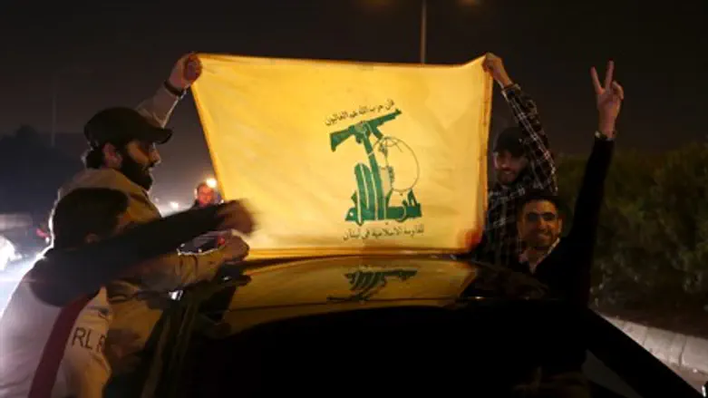 Hezbollah supporters hold a Hezbollah flag