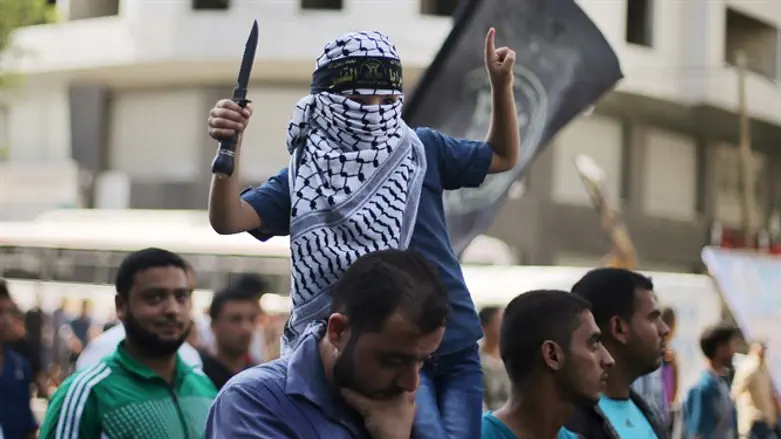 Arab child waves knife during Gaza City march