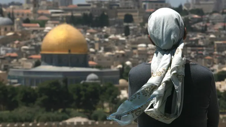 Jewish woman prays on Mount of Olives, overlooking Temple Mont