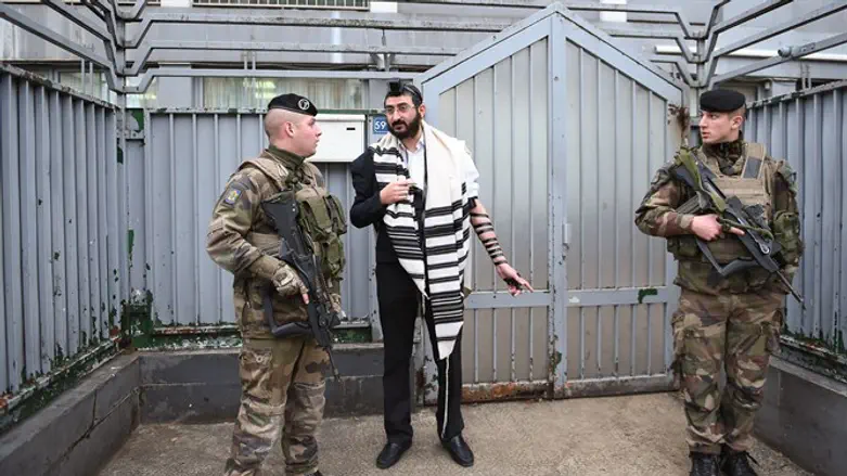 Soldiers guarding a staff member at a Chabad school in Paris, Nov. 16, 2015.