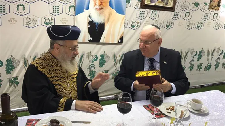 President Reuven Rivlin visits the sukkah of chief rabbis of Israel 