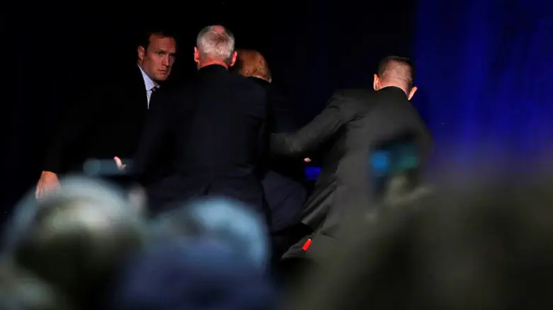 Trump rushed off stage by security