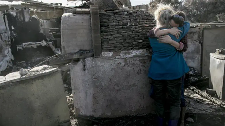 Rama and her daughter embrace amid ruins of their restaurant