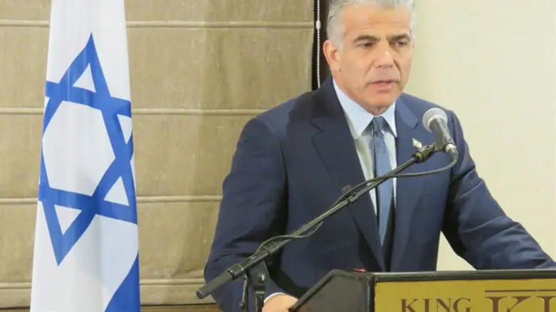 Lapid addressing foreign journalists