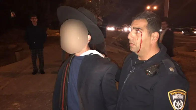Wounded officer and attacking demonstrator at Nitzan Junction