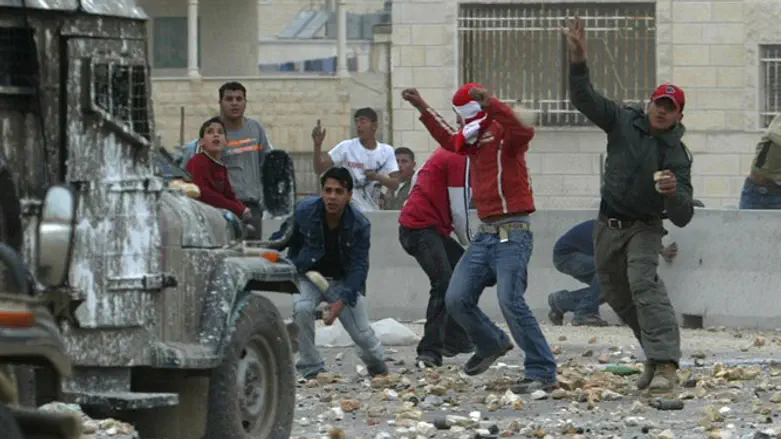 Arab rioter throws bottle