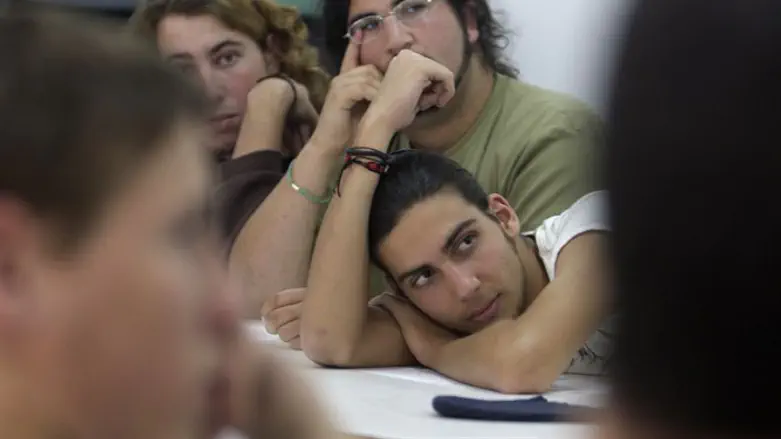Teenage boys listen in class at pre-army preparation program school in Yatir