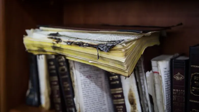 Partially burnt religious book in vandalized synaogue