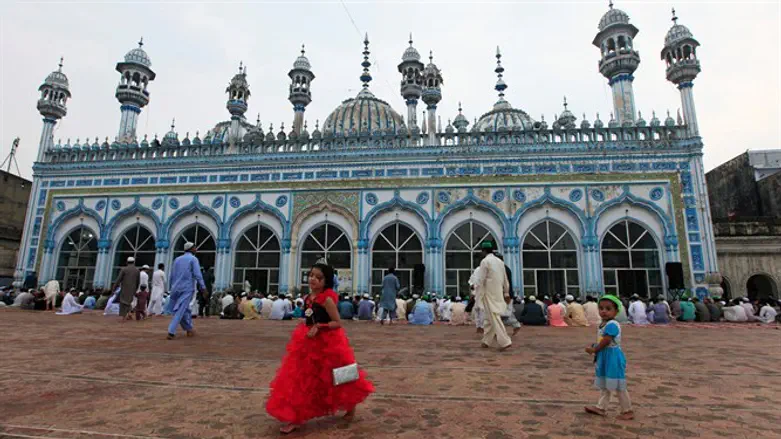 Girl walks inside mosque in Rawalpindi, Pakistan 