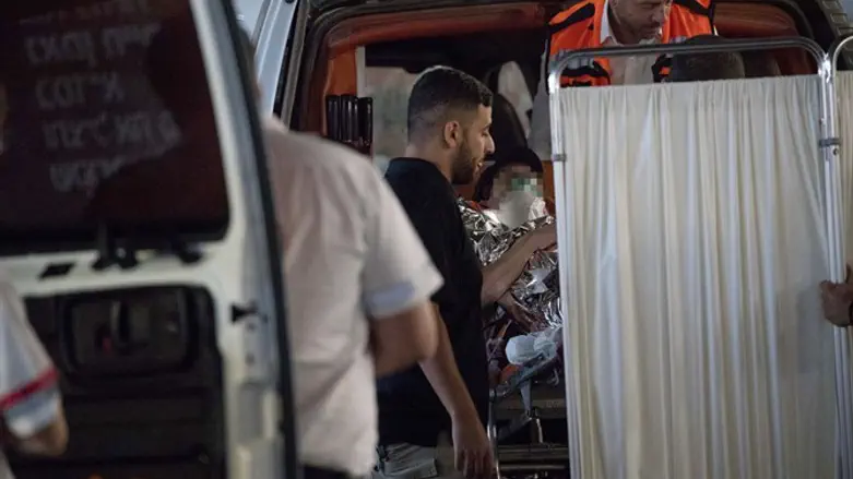 Paramedics treat victim from Halamish attack