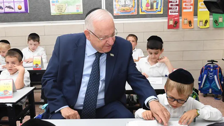 Israeli President Reuven Rivlin with a child on the first day of school