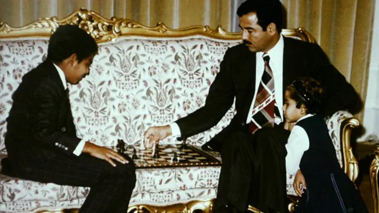 Saddam Hussein playing chess with son