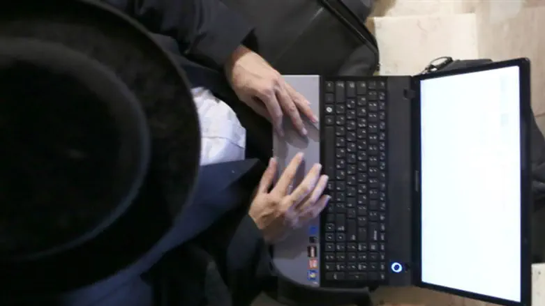 Haredi using a computer (illustrative)