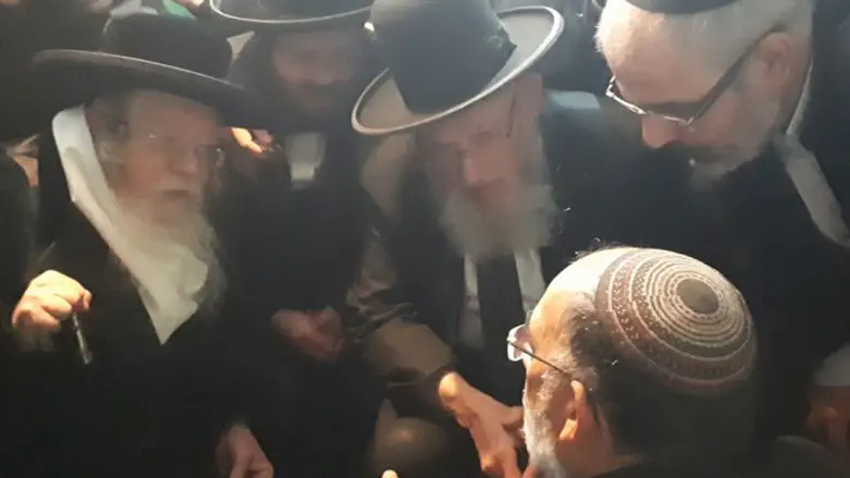 The  Kretchnif Rebbe, to the left, consoling a mourner. (illustrative)