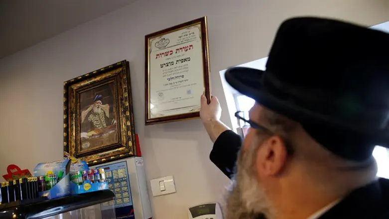 Kosher inspector hangs certification