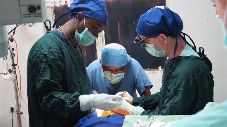 Dr. Morris Hartstein, center, frequently travels to Gondar, Ethiopia, to run clinics.